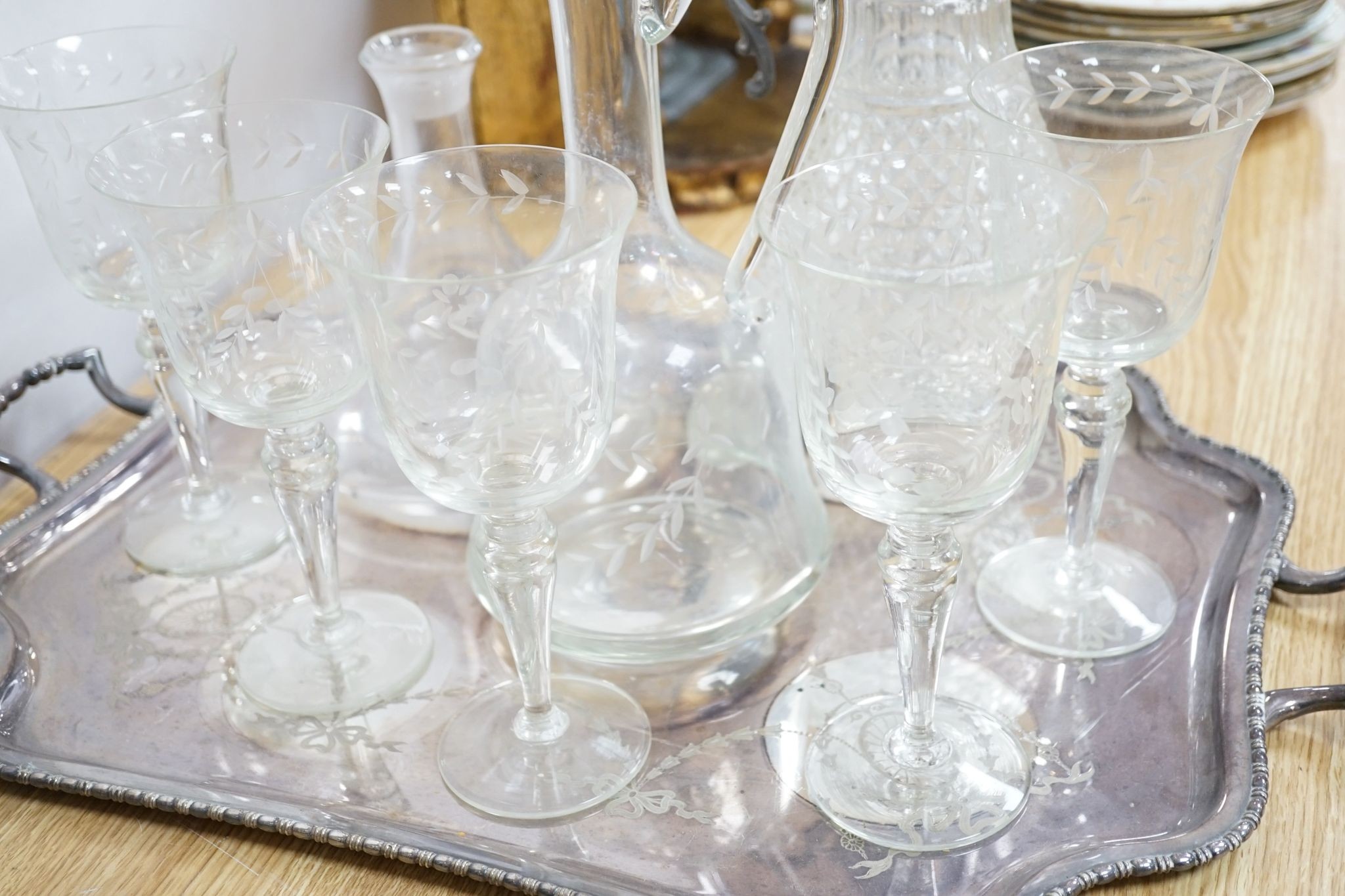 A plated two handled tea tray, a claret jug, two decanters and five glasses (9)